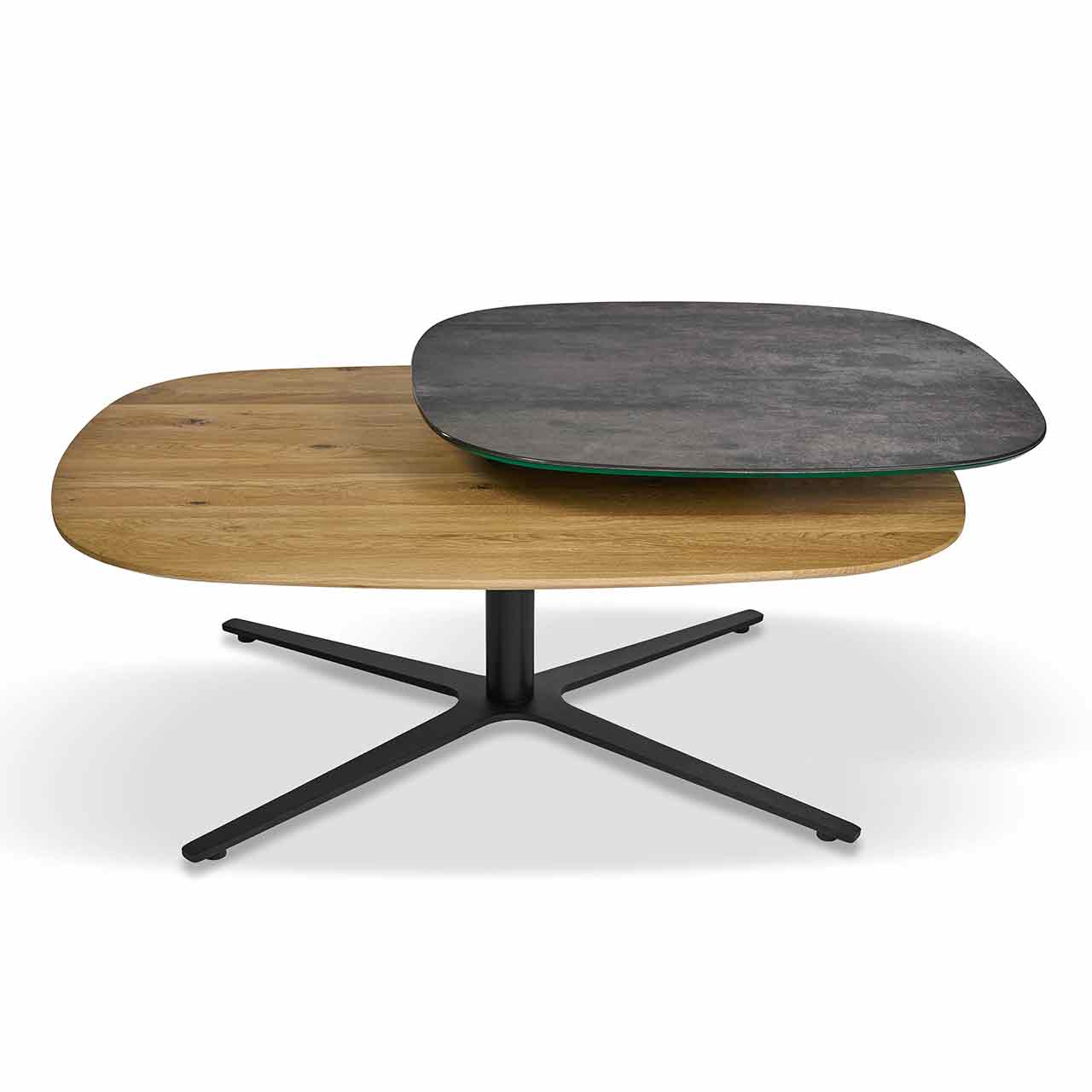 Ronald Schmitt - Couchtisch Orbit H 512 Couchtisch mit zwei abgerundeten Tischplatten, die obere kleinere Tischplatte ist dunkelgrau, die untere in hellem Holz. Schwarzes kreuzförmiges Gestell.